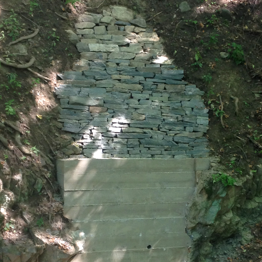 concrete retaining wall and secured to bedrock